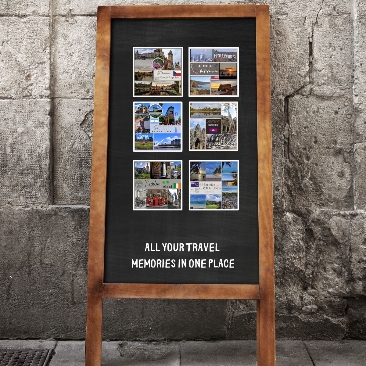 Wooden frame with black background displaying travel photos against a stone wall.