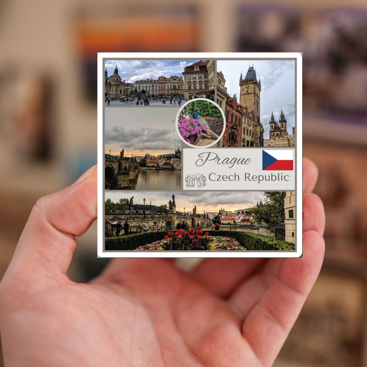 Hand holding a postcard with images of Prague, Czech Republic