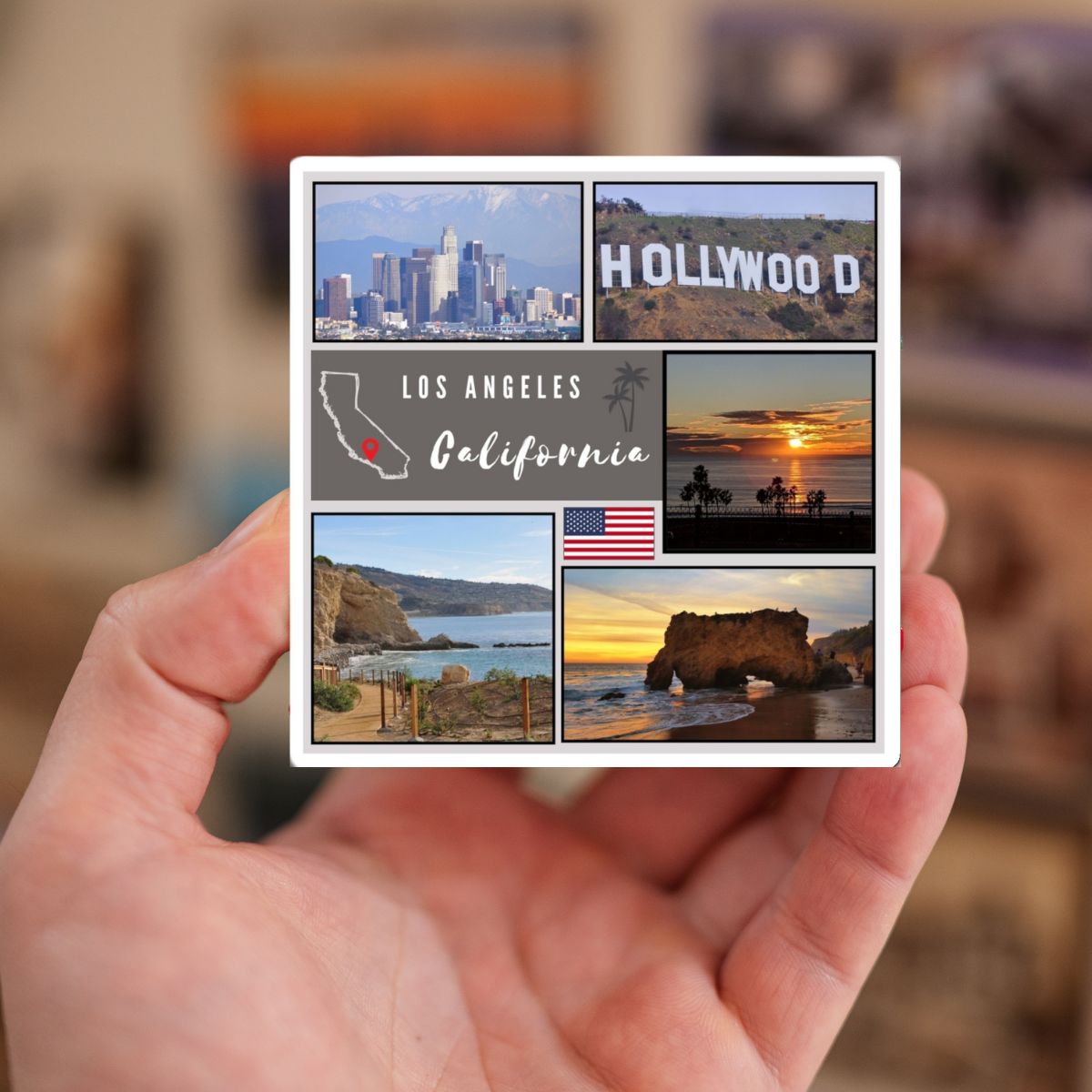 Hand holding a postcard with scenic views of Los Angeles and Hollywood.