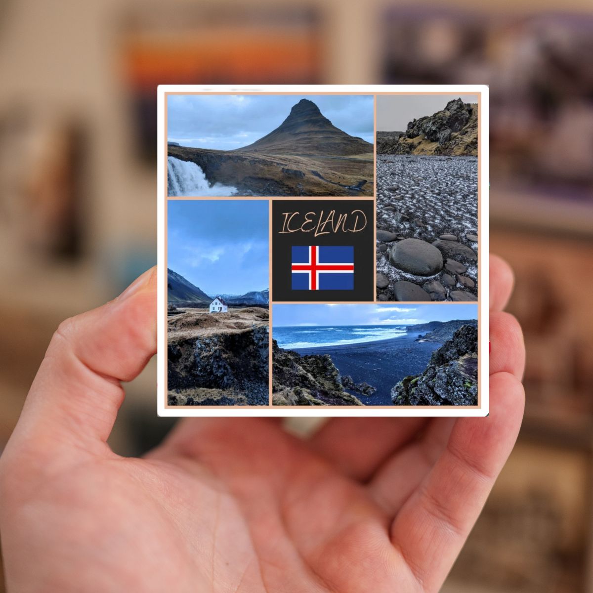 Hand holding a postcard with Iceland landscapes and flag