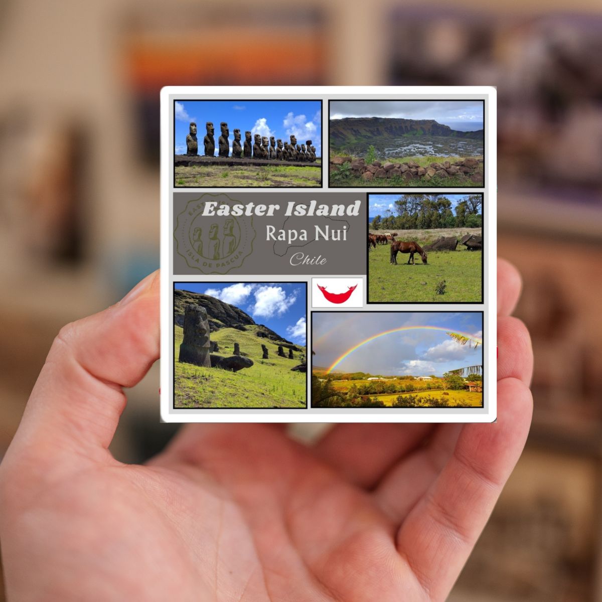 Hand holding a postcard with images of Easter Island and text 'Easter Island Rapa Nui Chile'.