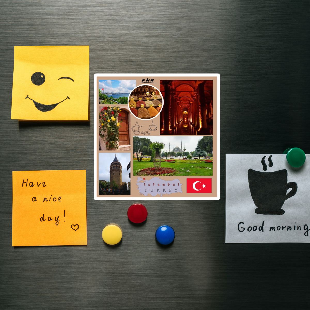 Collection of magnets on a metallic surface, including a smiley face, travel-themed magnet, and 'Good morning' magnet.