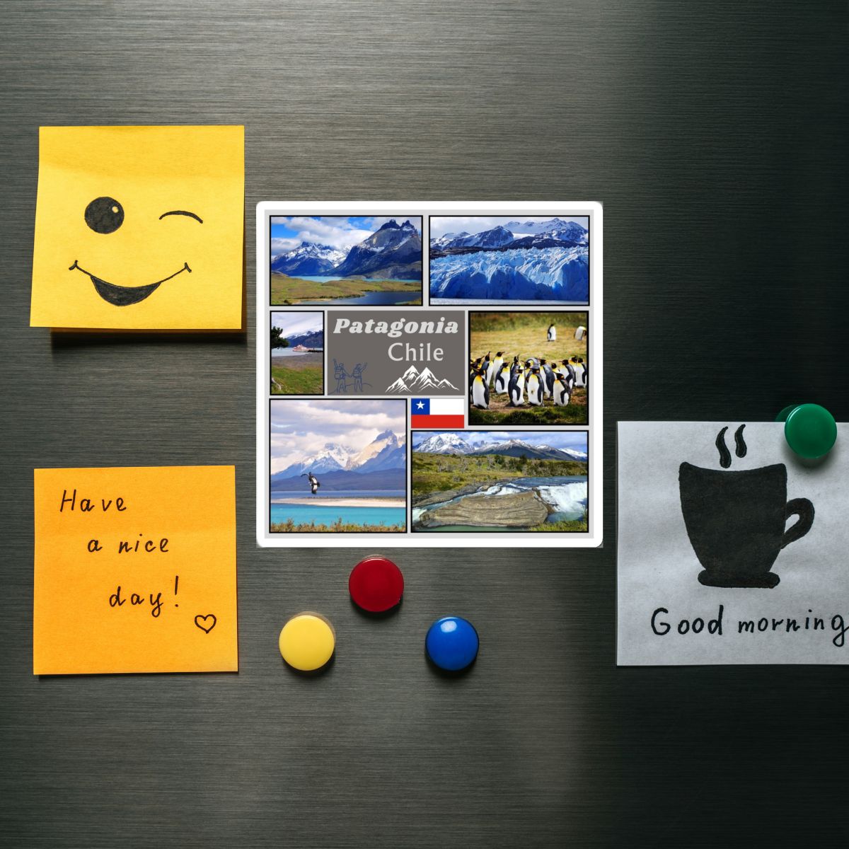 Fridge magnets with a smiley face, scenic collage, and motivational messages on a metallic surface.