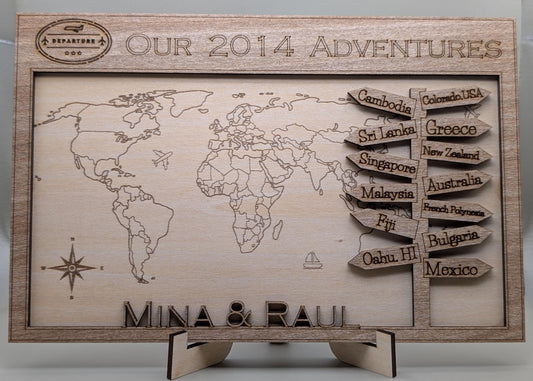 Wooden world map with engraved travel destinations