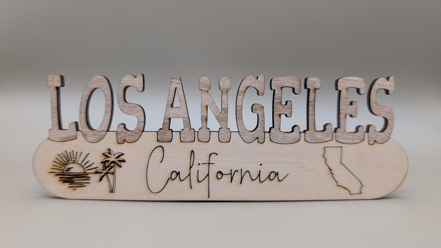 Wooden sign with 'Los Angeles California' on a gray background
