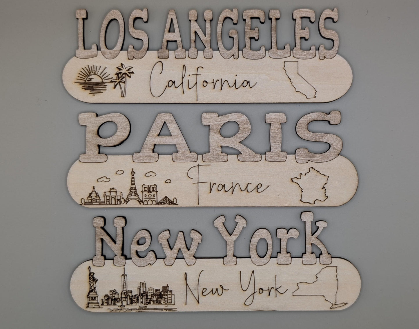 Decorative signs with city names and icons on a gray background