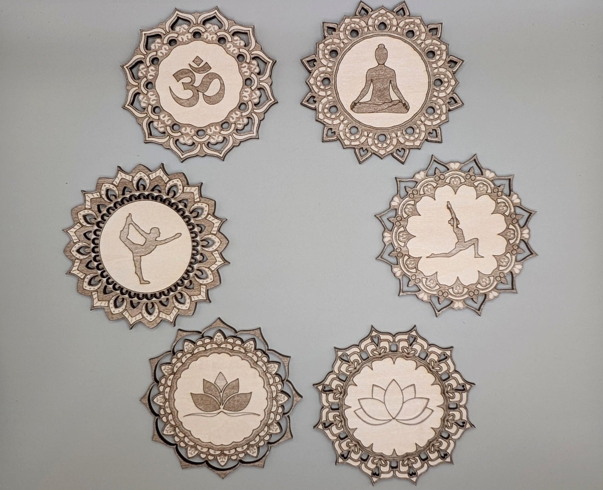 Set of six decorative plates with various symbols on a gray background