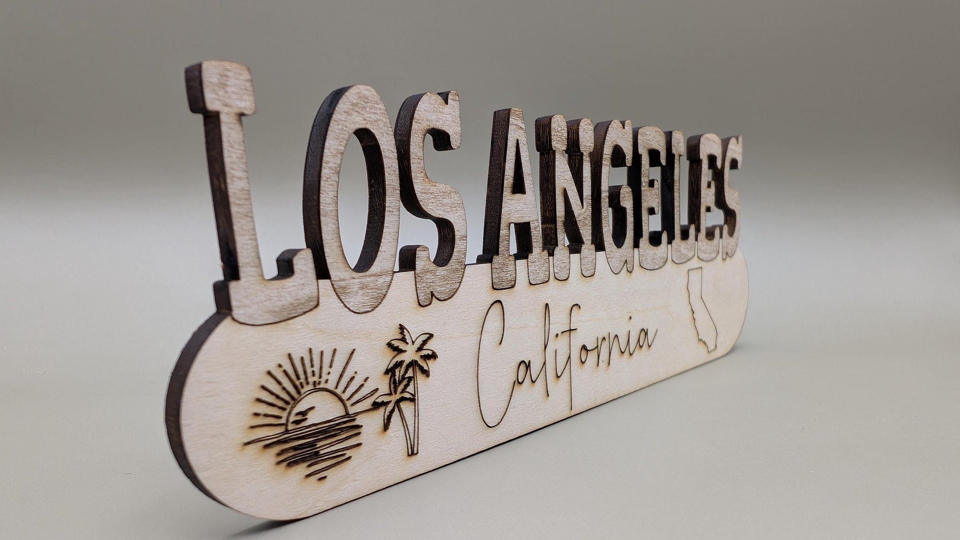 Wooden sign with 'Los Angeles California' text on a gray background