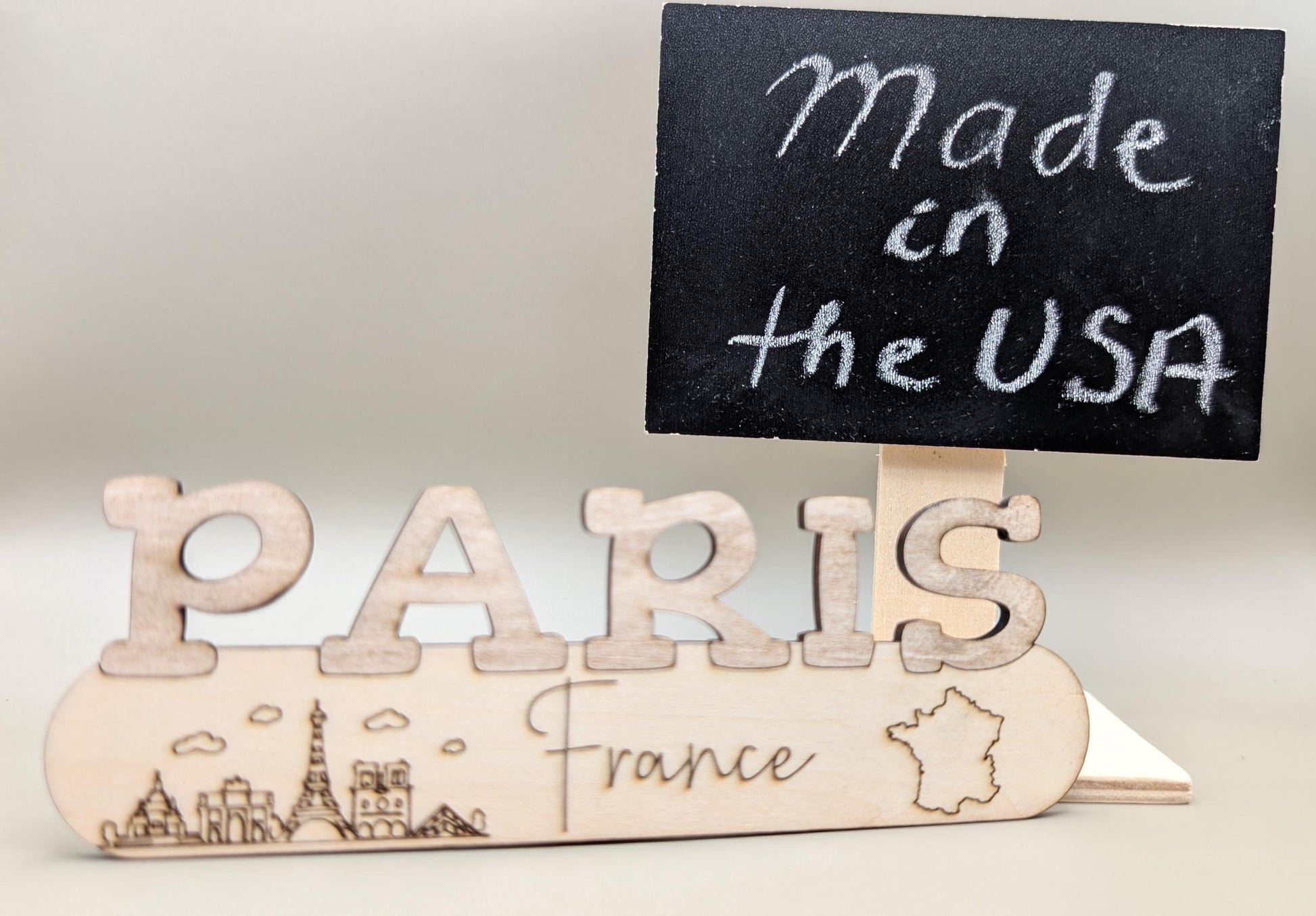 Wooden sign with 'PARIS France' and a small blackboard with 'Made in the USA' text.