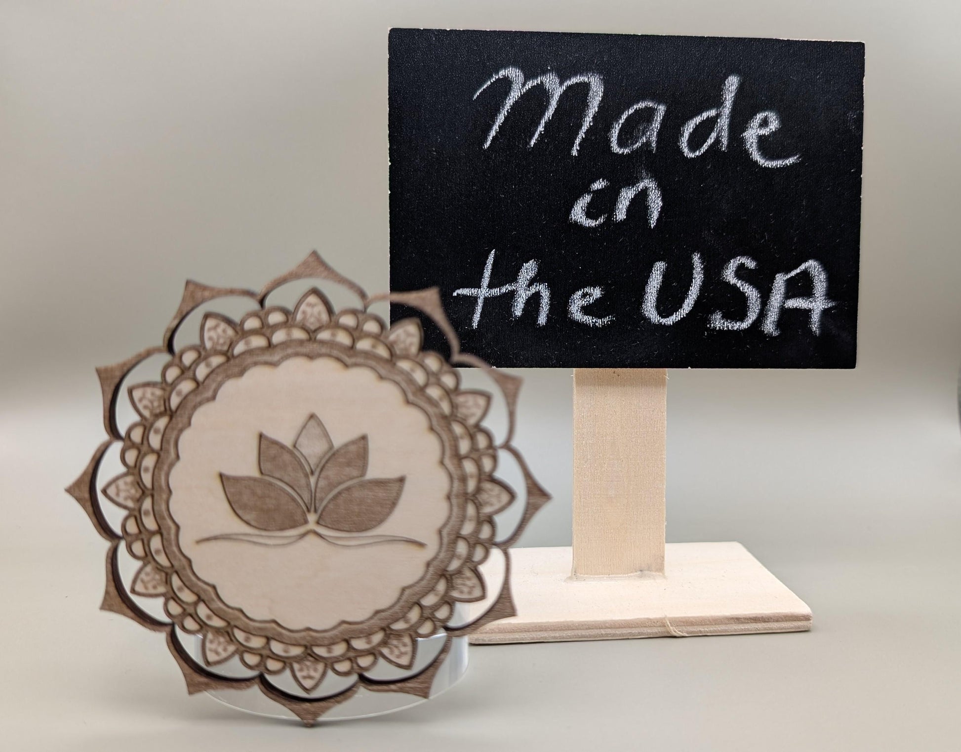 Wooden product with a leaf design and 'Made in the USA' sign on a stand.